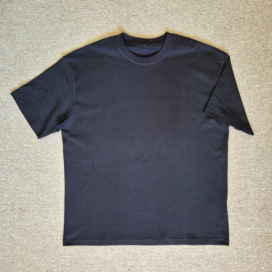 Black t-shirt on a textured beige surface