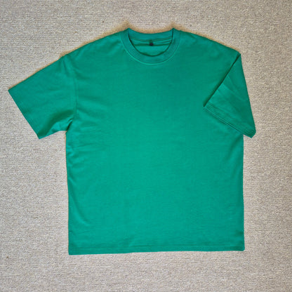 Green t-shirt on a gray textured surface