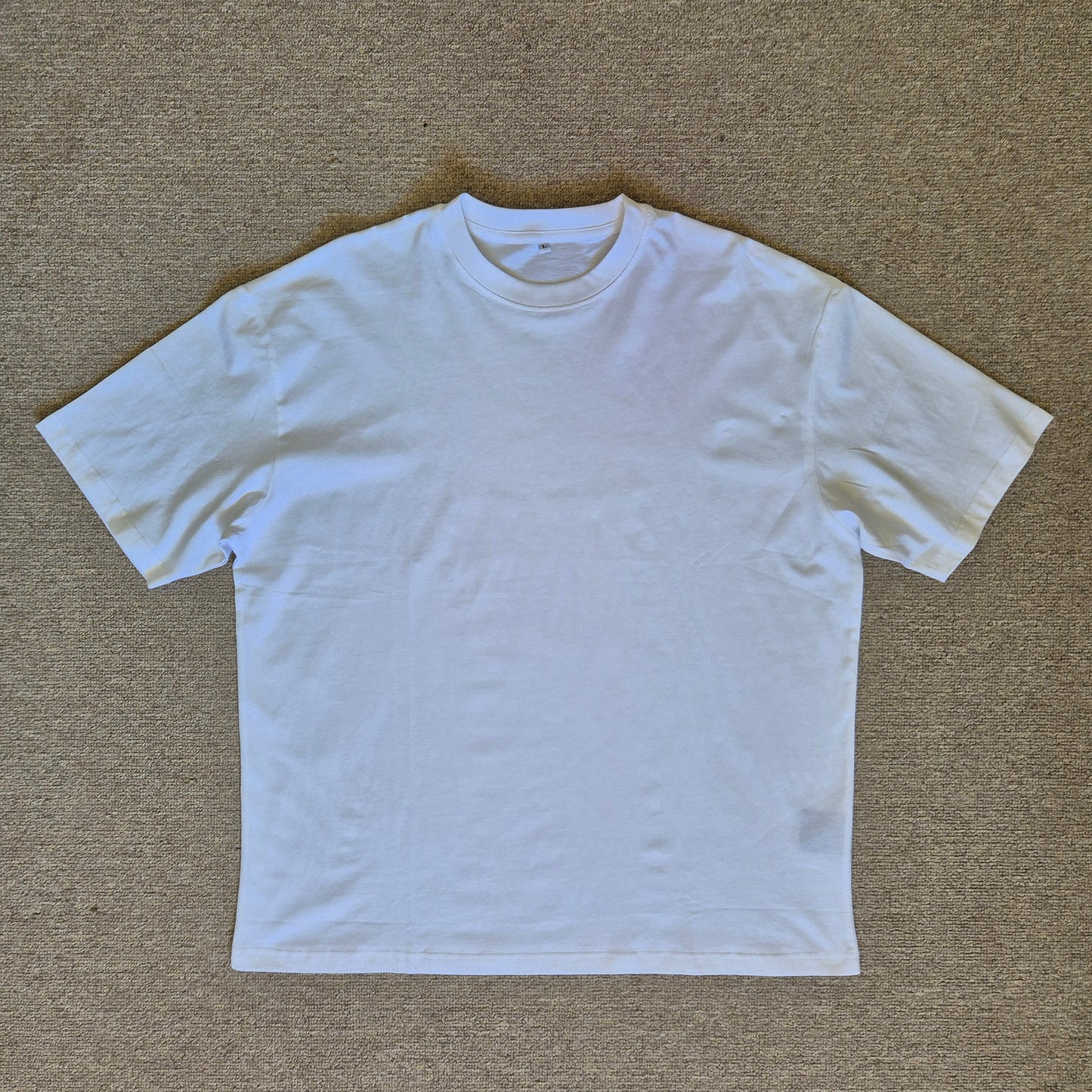 White t-shirt on a beige carpet